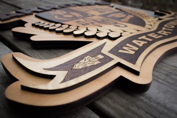 Close up view of lower details of wooden Watertown Arrows Emblem